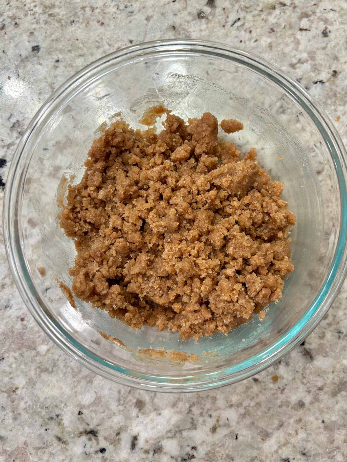 Streusel topping in a glass bowl on the counter for banana bread topping.