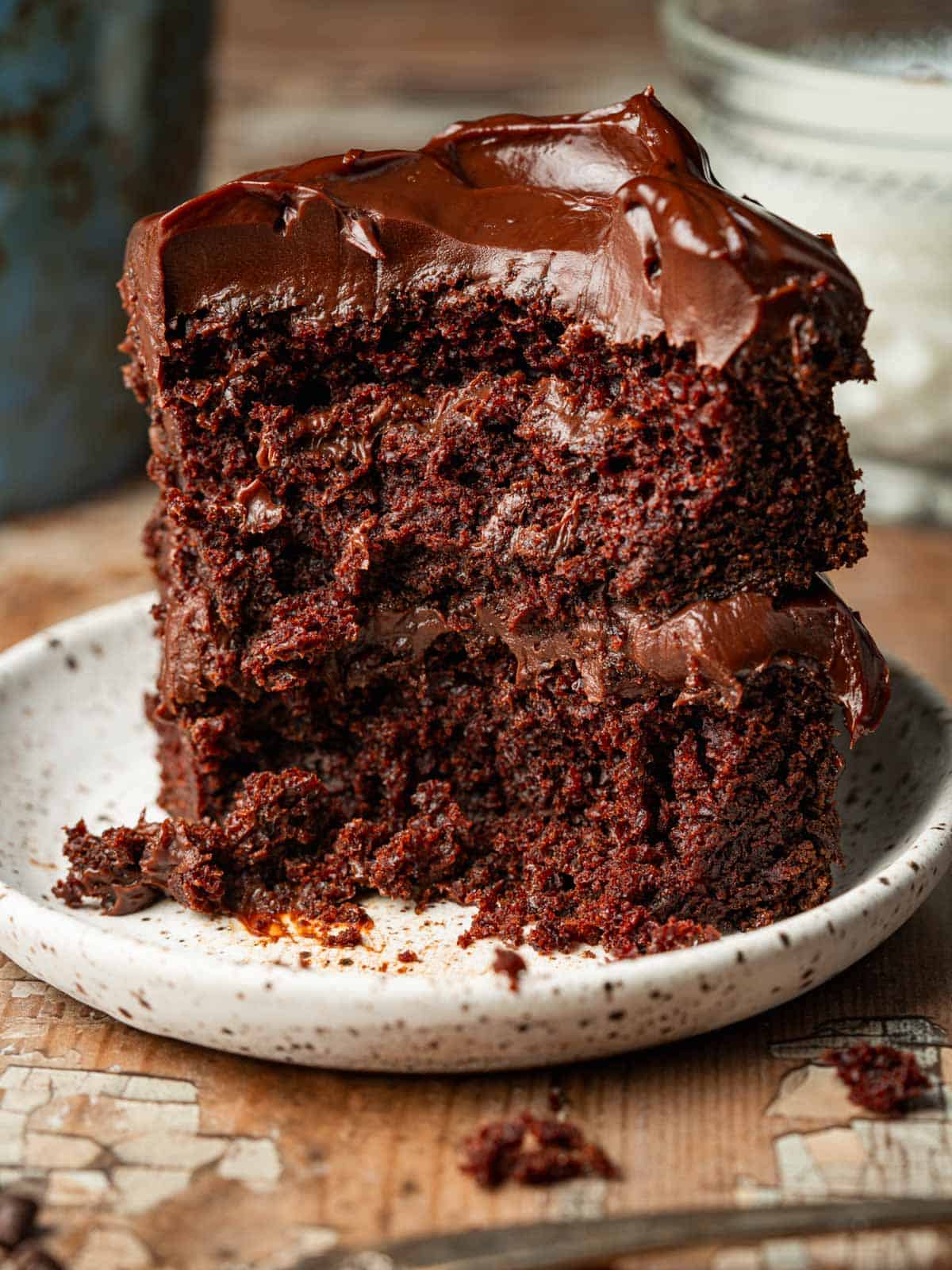 Chocolate on chocolate cake on a white plate with a fork.