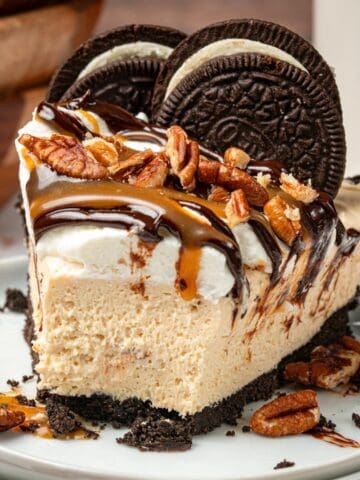 Caramel no bake pie with pecans, chocolate, and caramel on top.