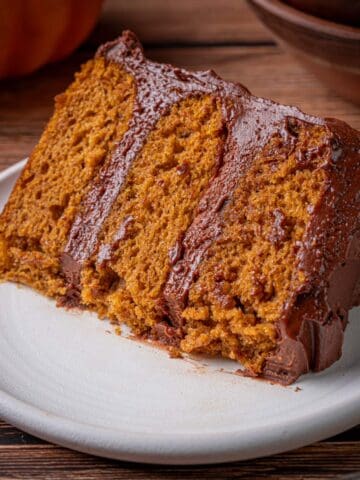 Pumpkin chocolate cake slice on a plate with a fork.
