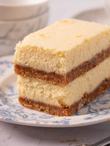A closeup of the mascarpone cheesecake texture and graham cracker crust on a plate.